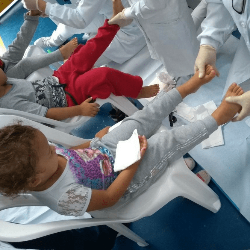 Doutora examina os pés de uma criança